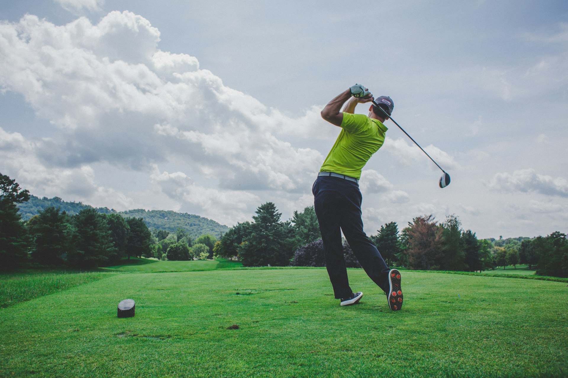 Golfer swinging a driver on the tee